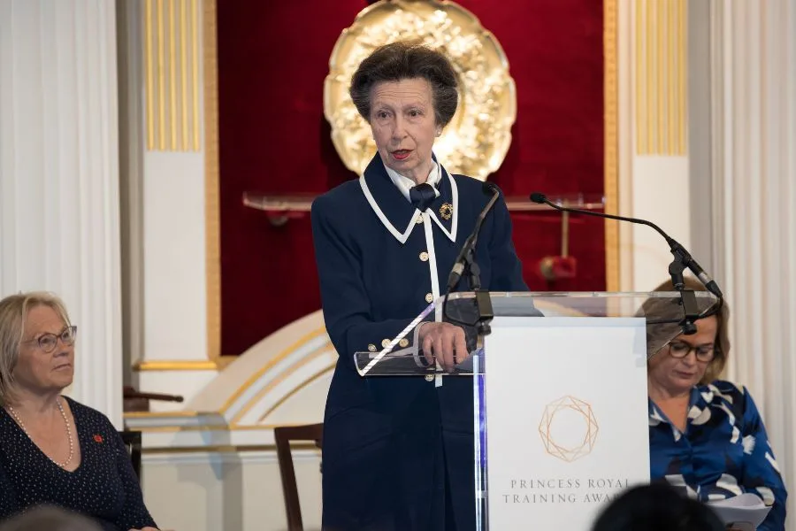 HRH Princess Anne speaking at a podium.