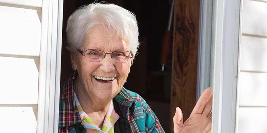 Lady waving under what happens when live in Caregivers need a break or vacation