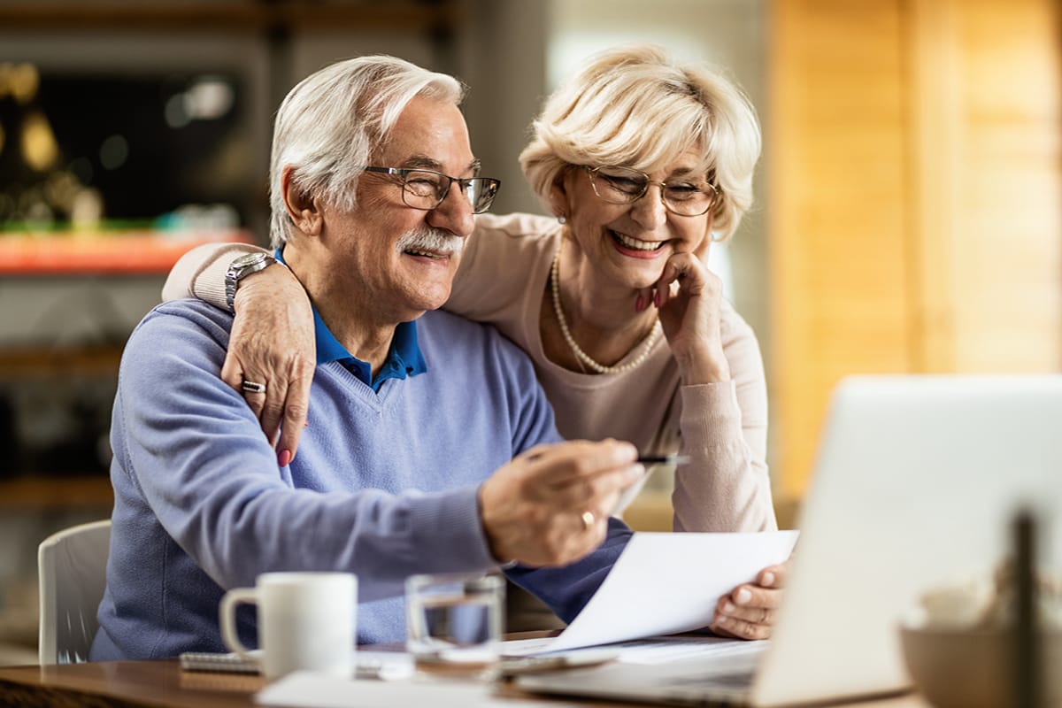 Elderly couple reviewing their finances for care