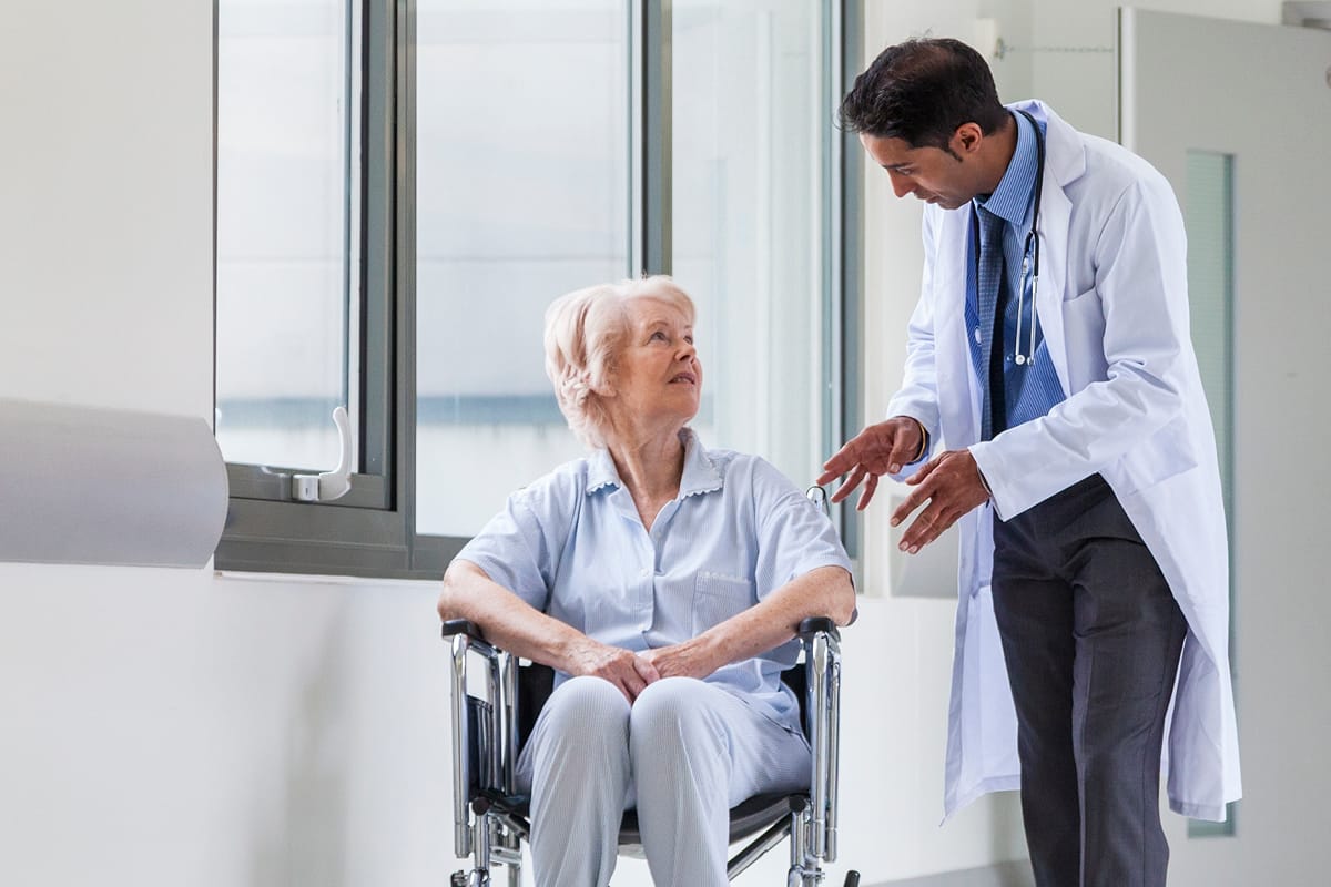 Elderly lady speaking with an NHS doctor under NHS Continuing Healthcare section of page