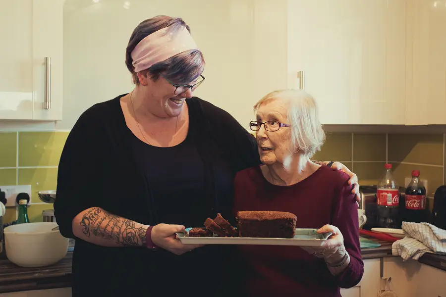 client and Caregiver enjoying cake together