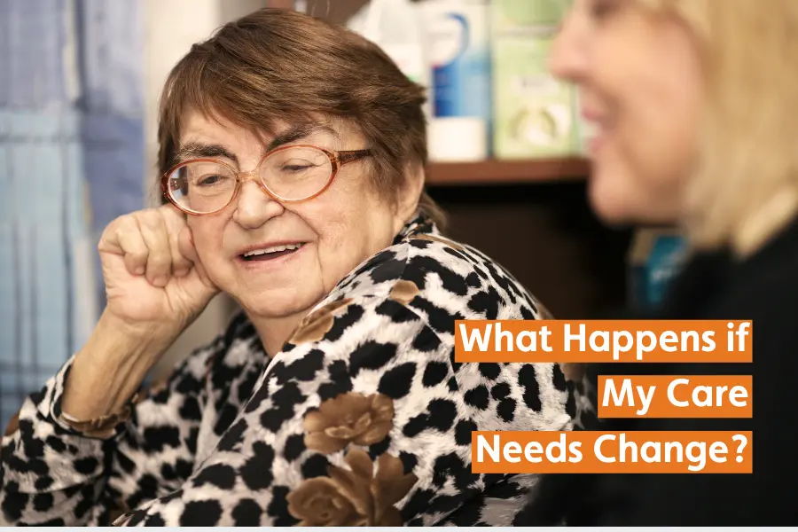 An elderly woman with glasses and a patterned blouse is smiling and talking to another person. The text on the image reads, "What Happens if My Care Needs Change?"