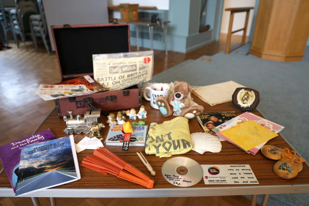 A group of items from a memory box displayed on a table at the family dementia workshop