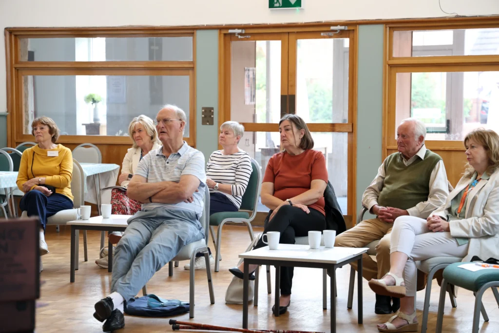 Attendees sitting and listening to Jayne Vale presenting at the Family Dementia Workshop.