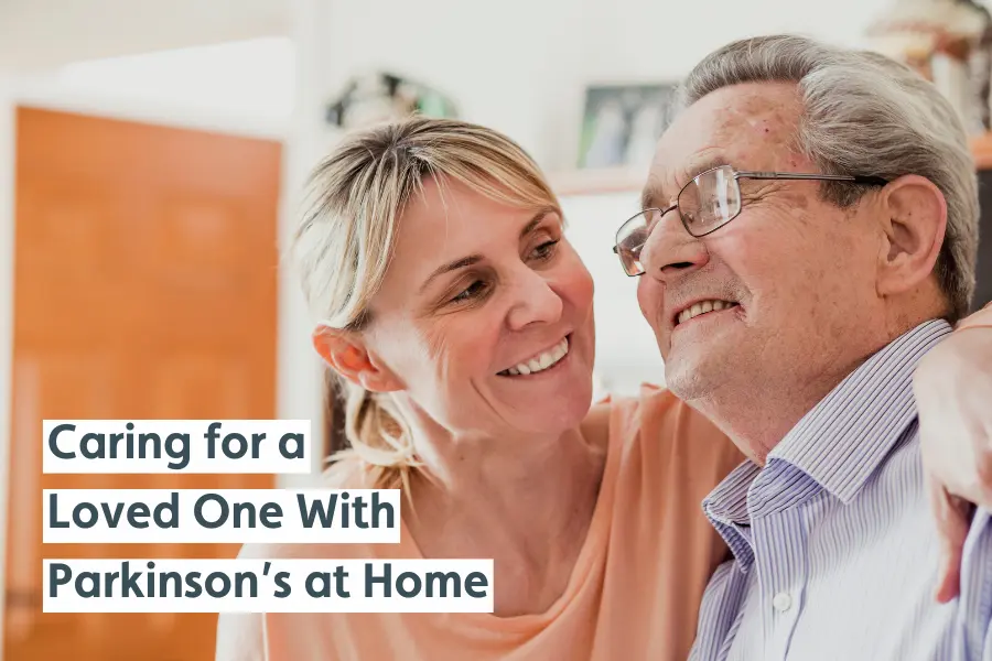 A woman smiles warmly with her arm around an older man with glasses. The text reads, "Caring for a Loved One With Parkinson’s at Home."