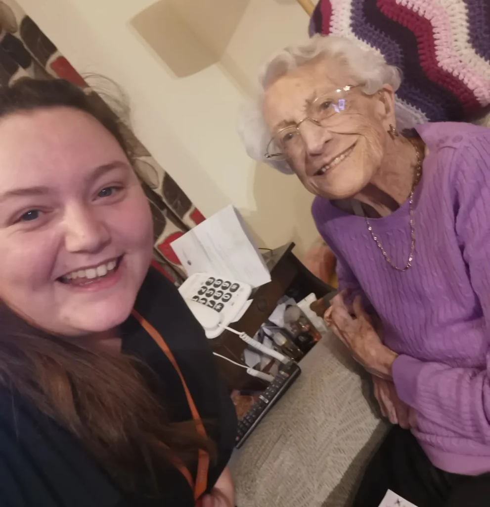 Caregiver, Emma smiling for a selfie with her client