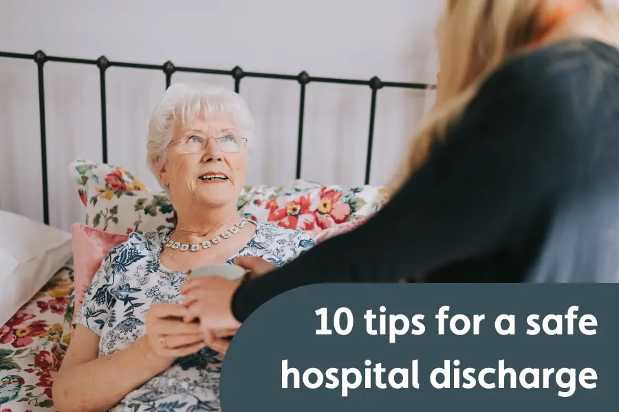 Elderly woman sitting up in bed, smiling as a caregiver hands her a cup. Text overlay reads: '10 tips for a safe hospital discharge'.